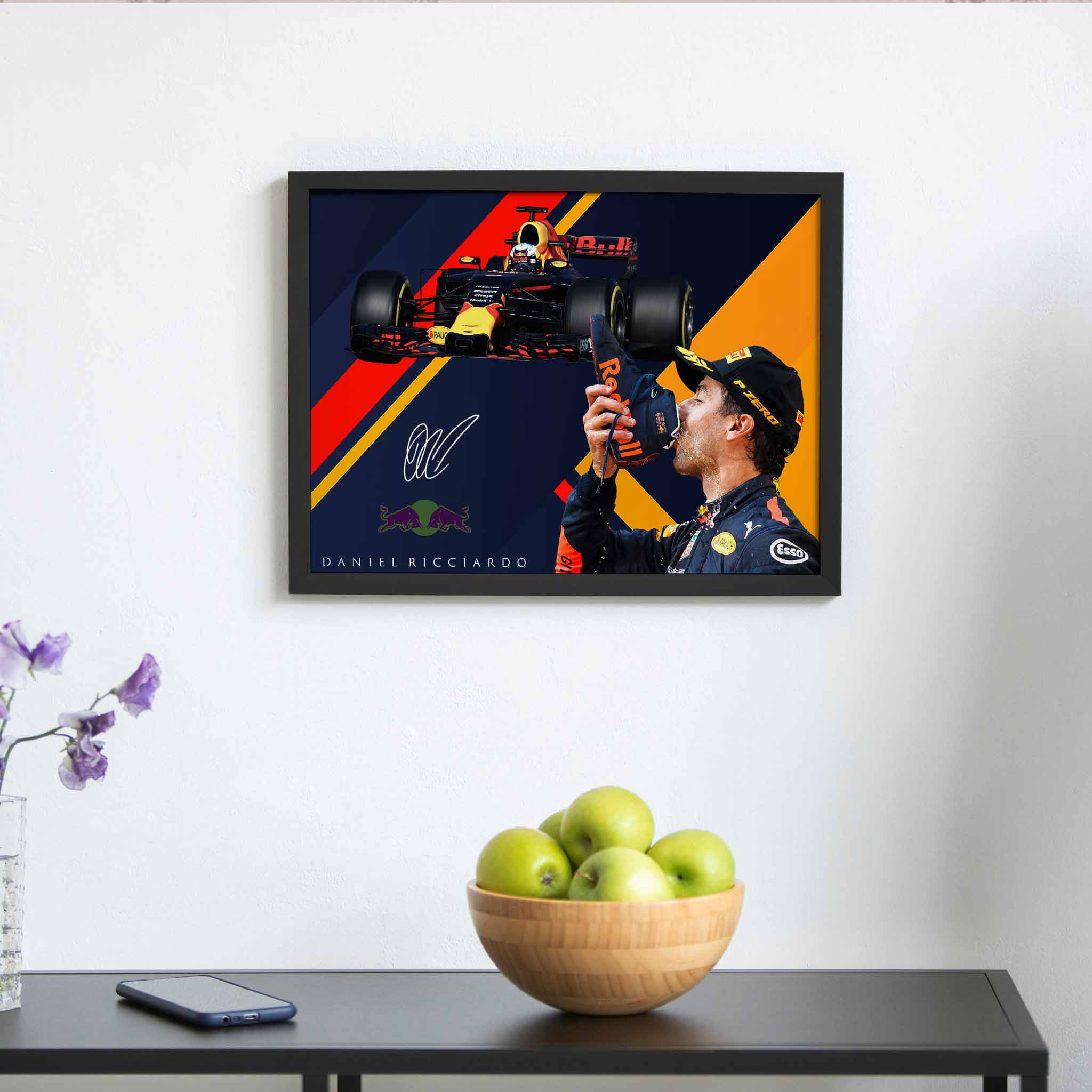 Daniel Ricciardo framed art displayed on a fans wall above a fruit bowl.