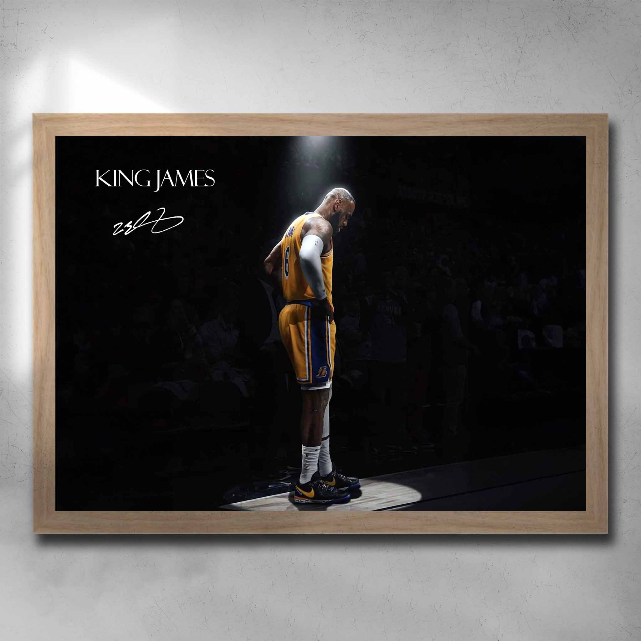 Oak framed King James art by Sports Cave, showcasing the legendary basketball icon spotlighted against a blurred audience background.