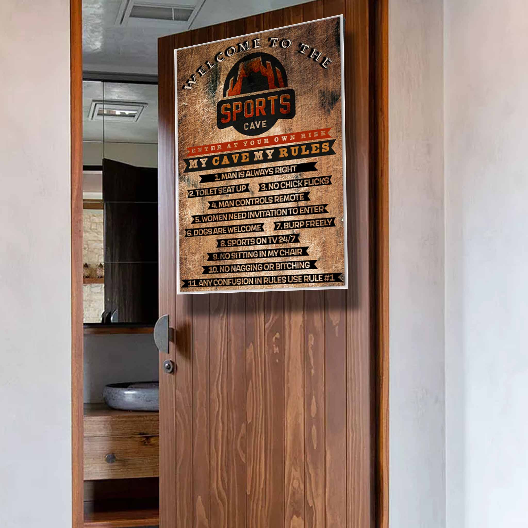 A "Man Cave" sign on a wooden door lists humorous rules like "Man is always right," "No chick flicks," and "Sports on TV 24/7." The sign is titled "Welcome to the Sports Cave" with a rustic design.