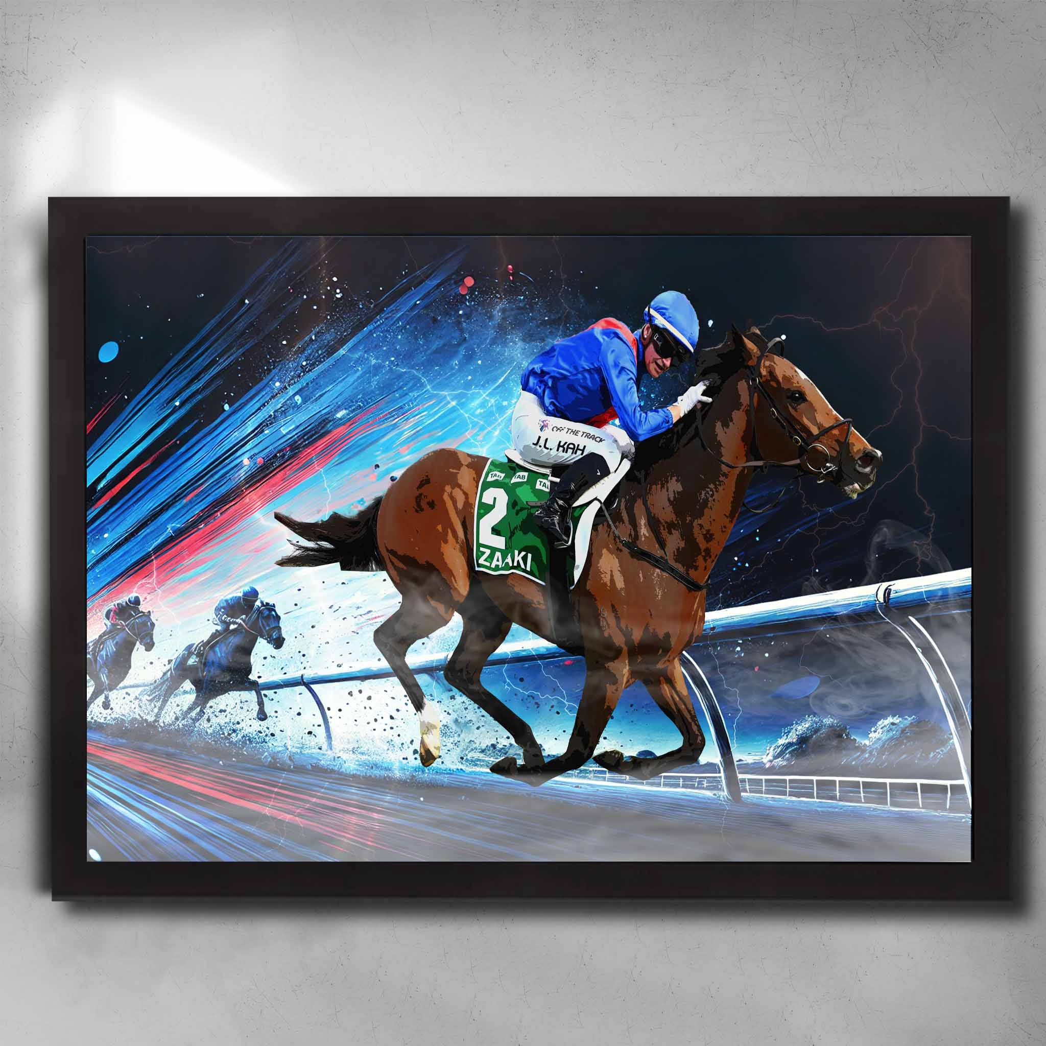 Zaaki horse racing art black framed poster with Jamie Kah in blue and red silks, capturing dynamic mid-race action. Ideal for horse racing fans and man cave decor.